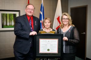 Florence Barron being presented the Order of the Red Cross.